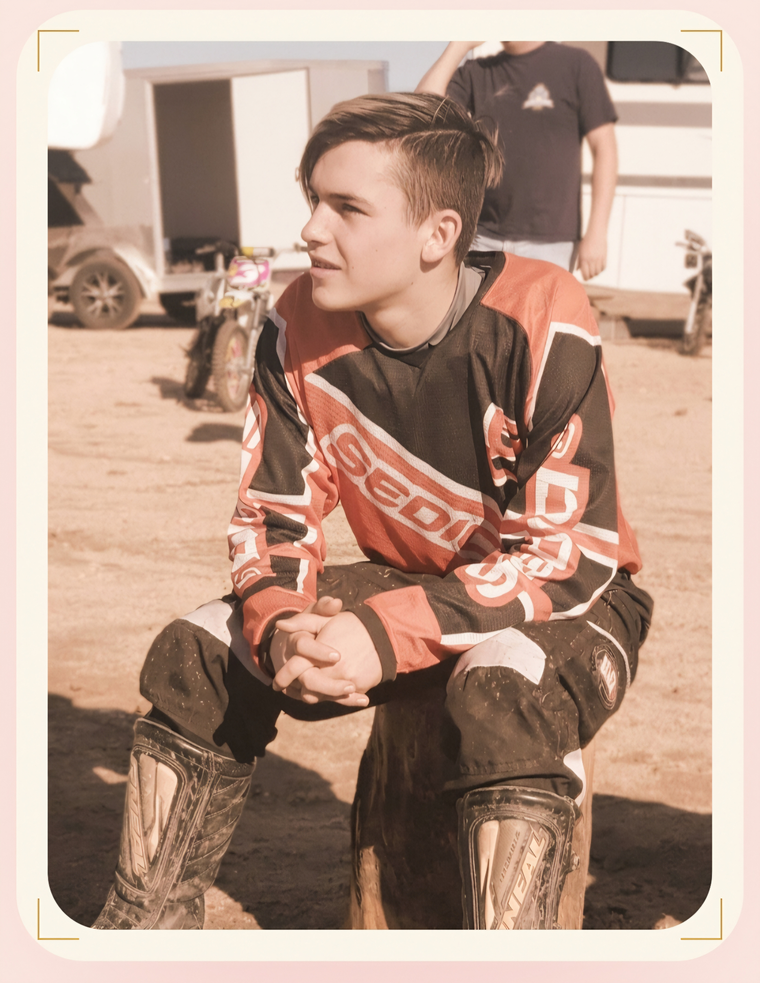 Dillon, Michele's son, sitting outside in motocross gear